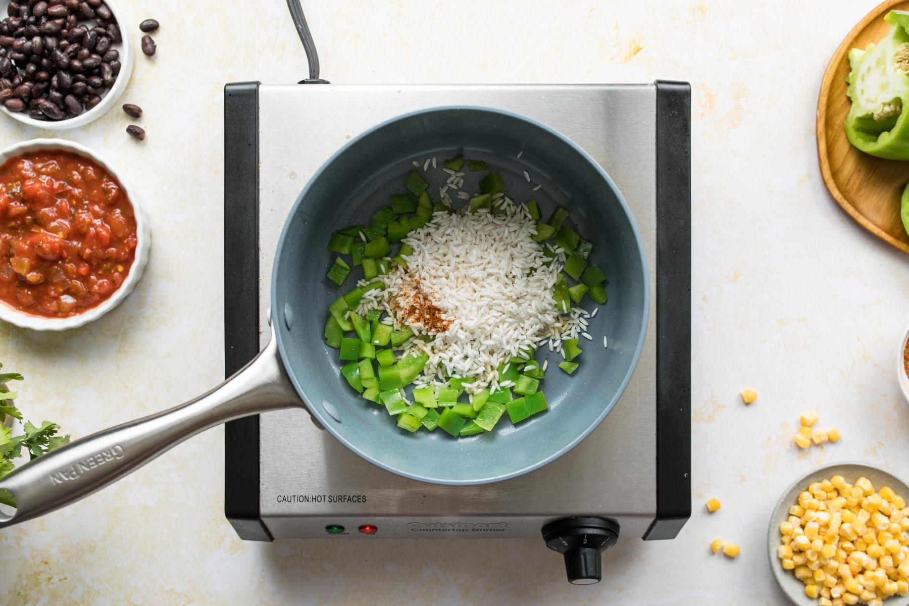 rice and bell peppers in a pot