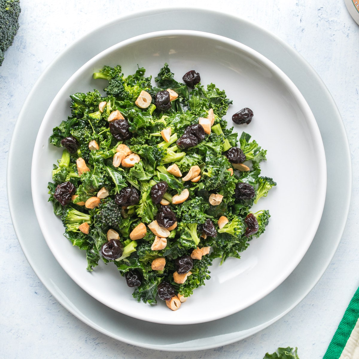 square image of kale salad in a bowl