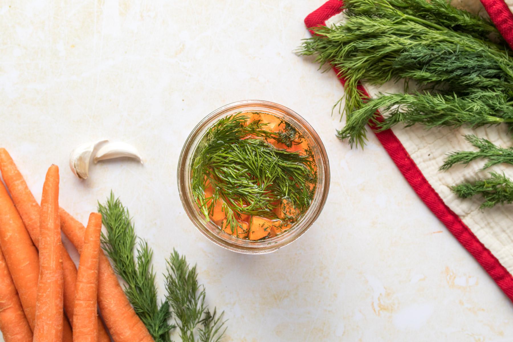 dill and carrot slices in jar