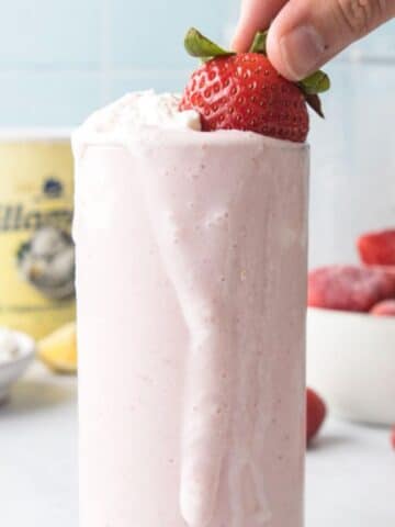 whole strawberry and whipped cream in glass