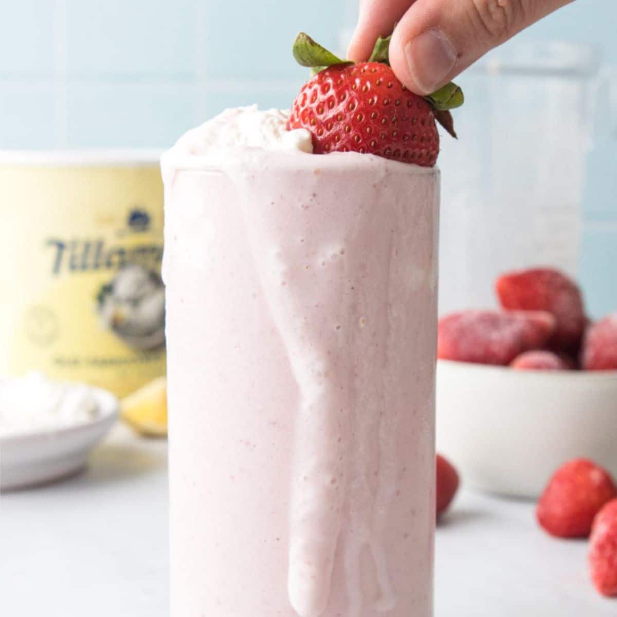 whole strawberry and whipped cream in glass