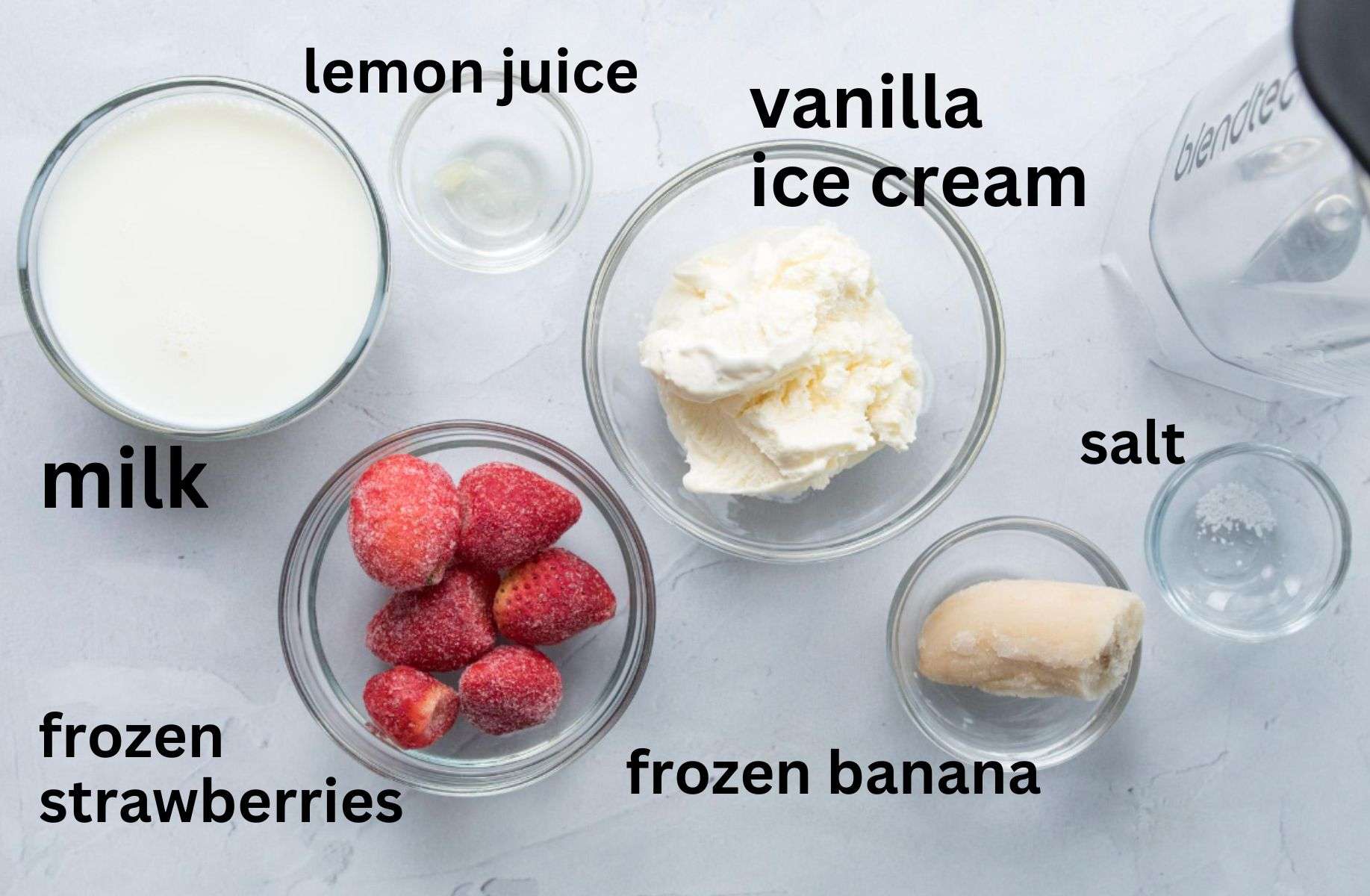 strawberries, banana, milk, ice cream on table