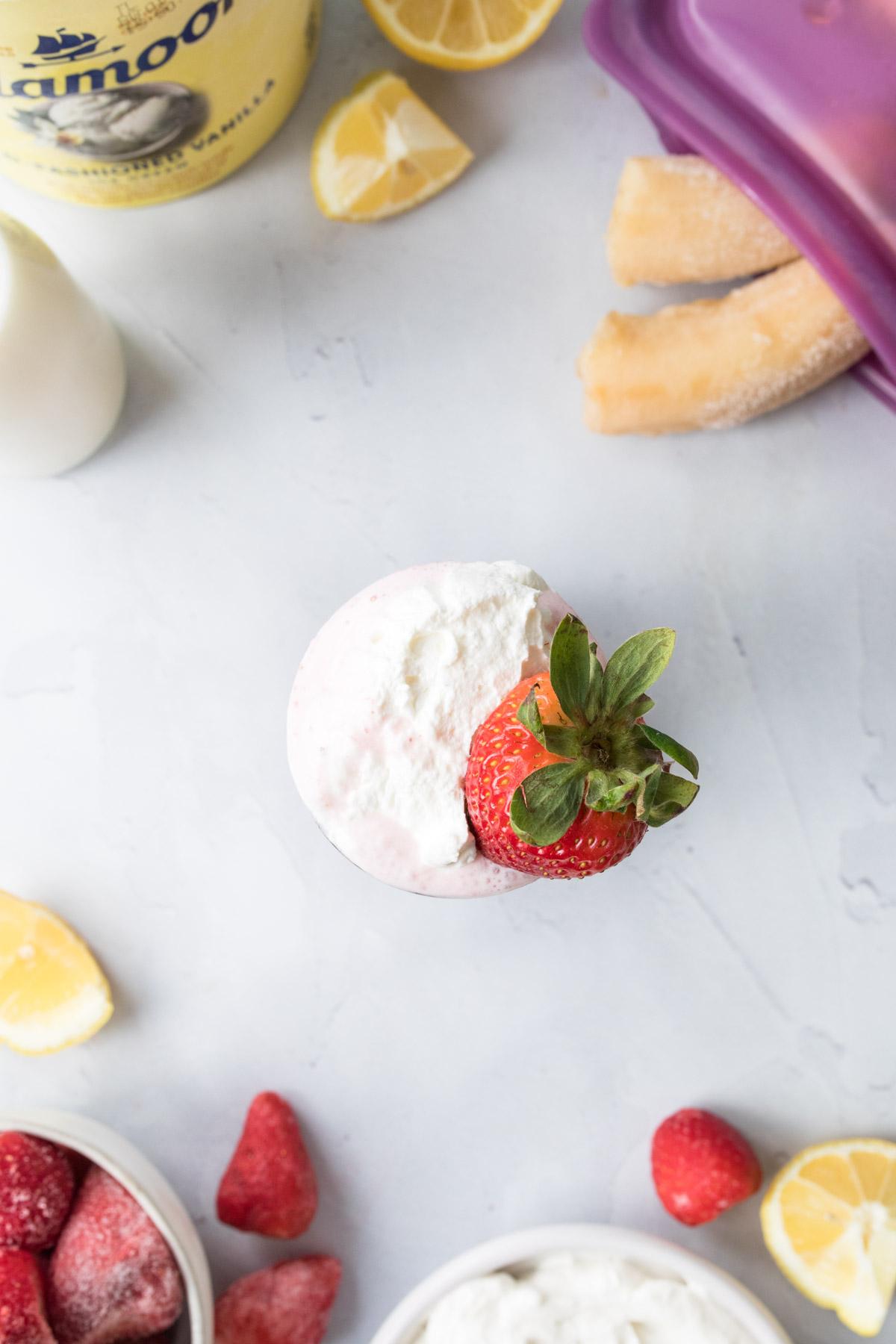 whipped cream and strawberry in glass