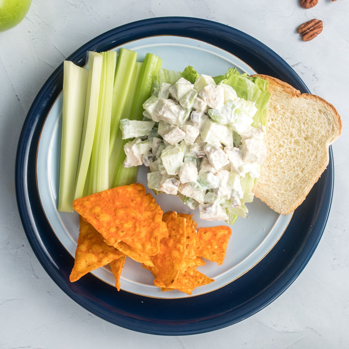 open faced chicken salad sandwich with sides on plate