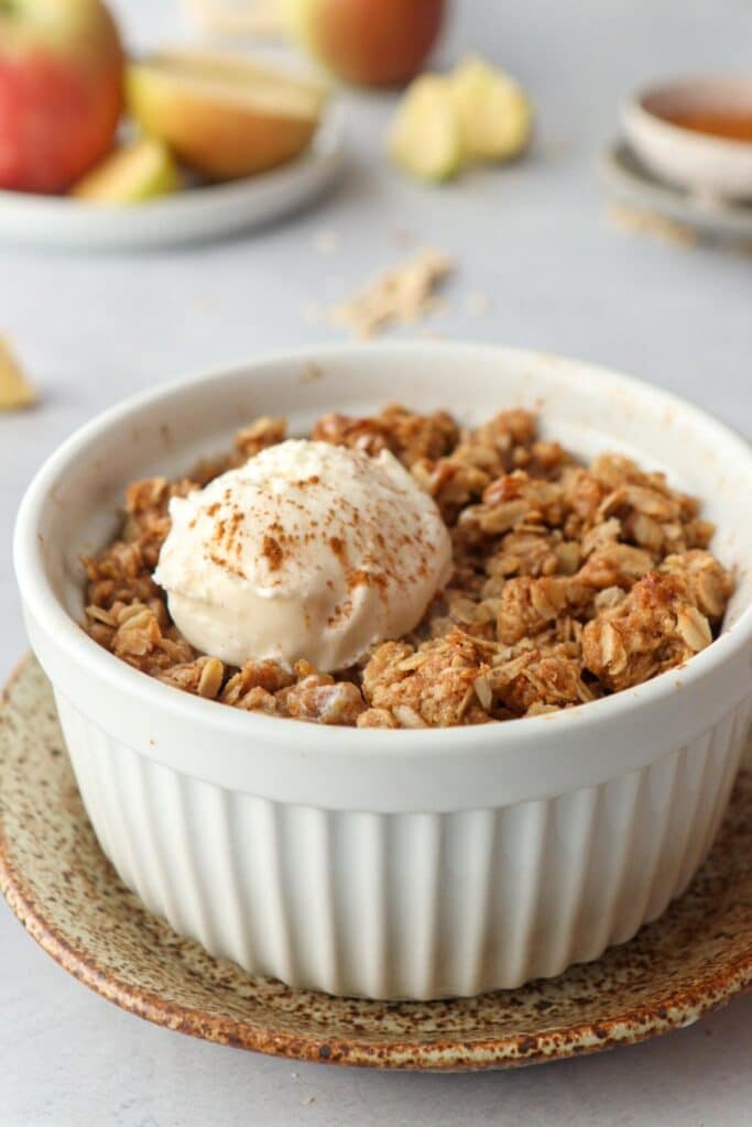 apple crisp in bowl with ice cream on top