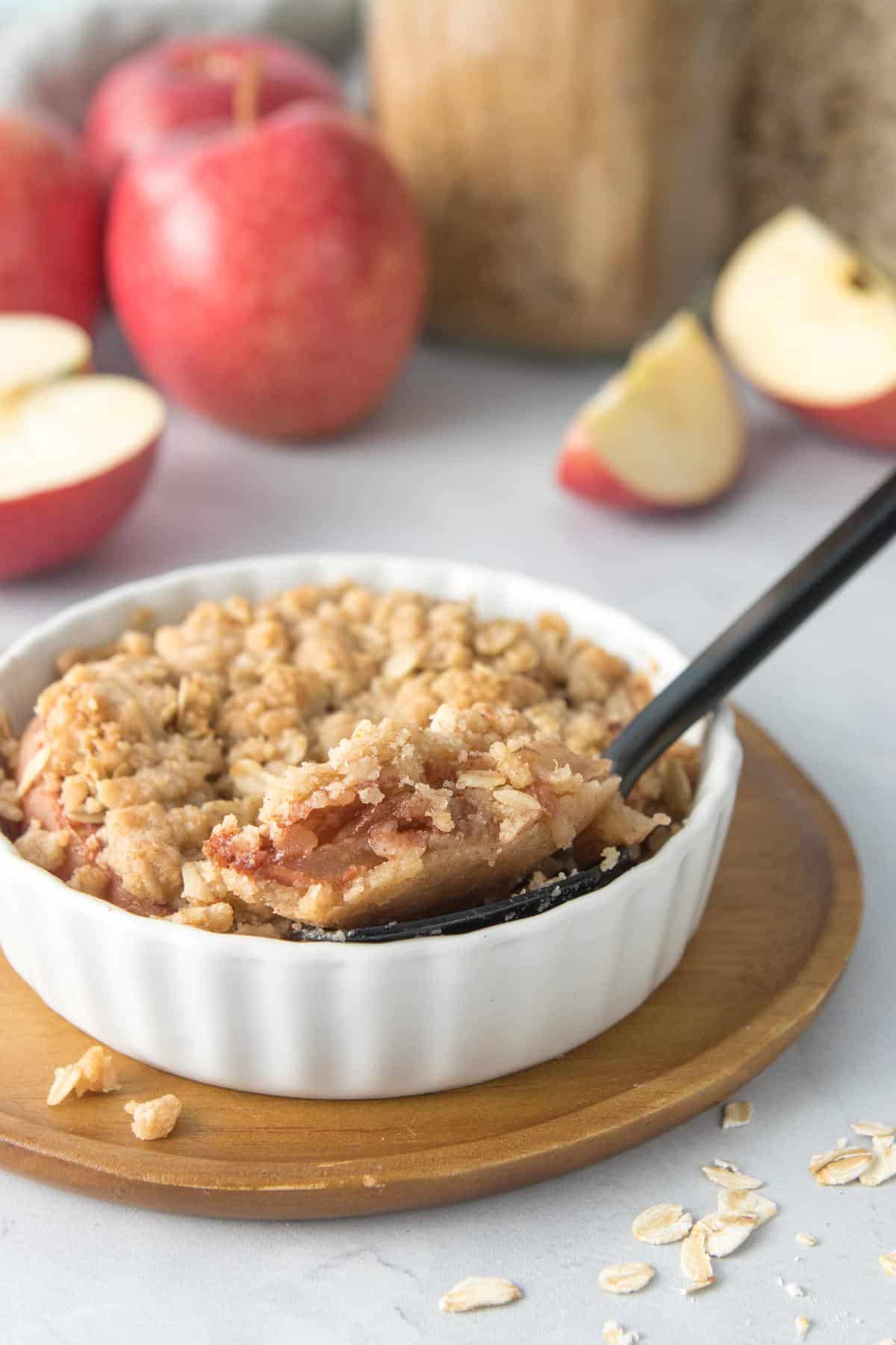 spoonful of apple crumble in dish