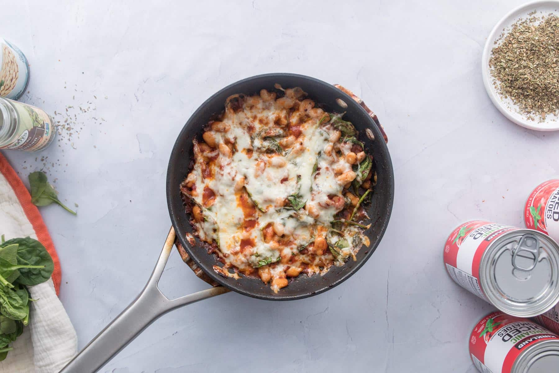 tomatoes beans and cheese in skillet