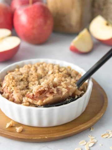 spoonful of apple crumble in dish