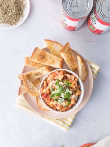 beans and tomatoes in dish with cut toast