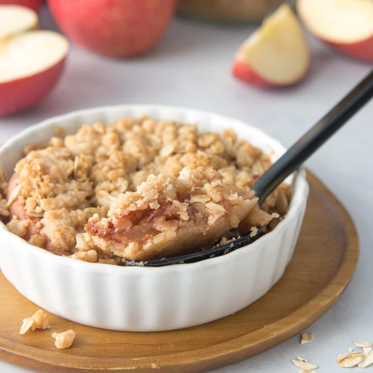 spoonful of apple crisp in dish, square