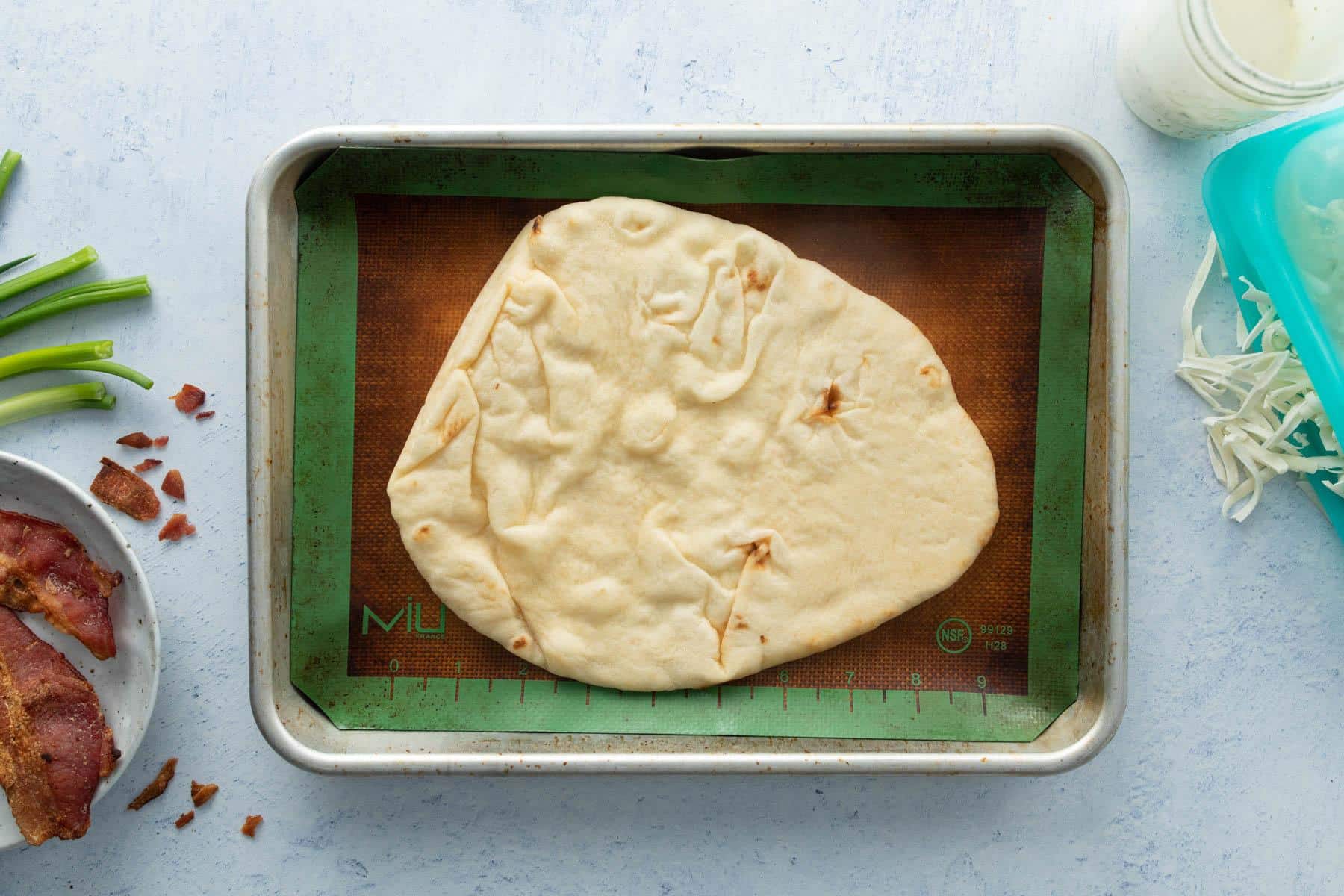 flatbread on baking sheet