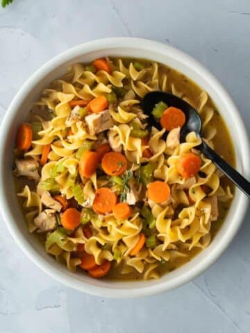 bowl of egg noodles, carrots in bowl