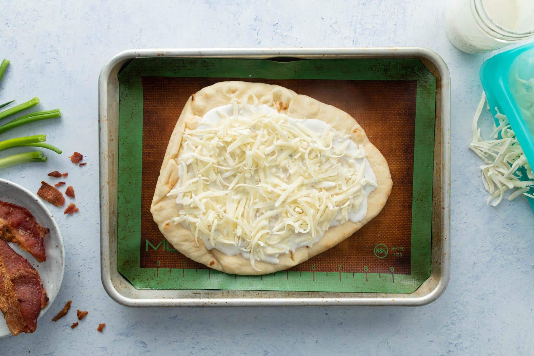 flatbread with ranch and cheese on it