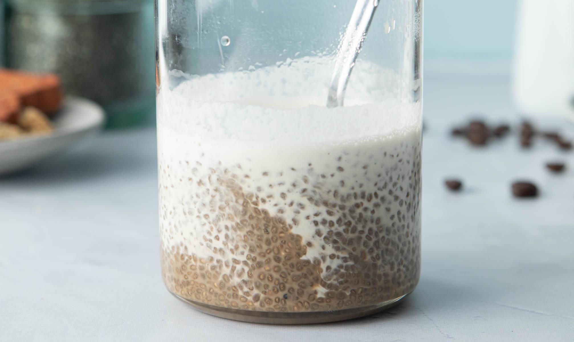 spoon in glass of chia seeds, coffee, cream