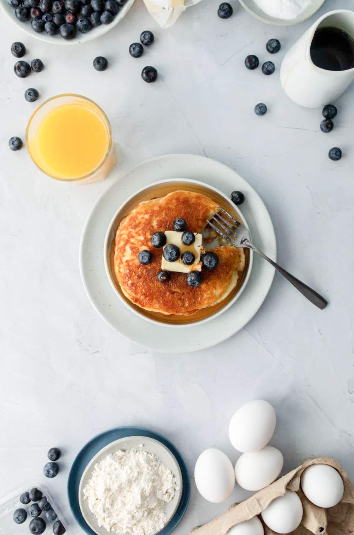 stack of pancakes with blueberries and butter