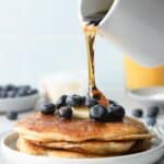 plate of pancakes with blueberries and butter