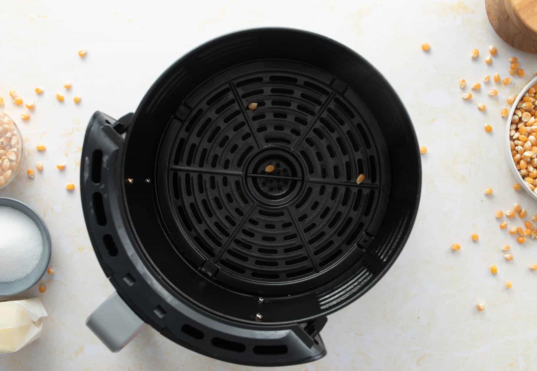 couple popcorn kernels in air fryer basket