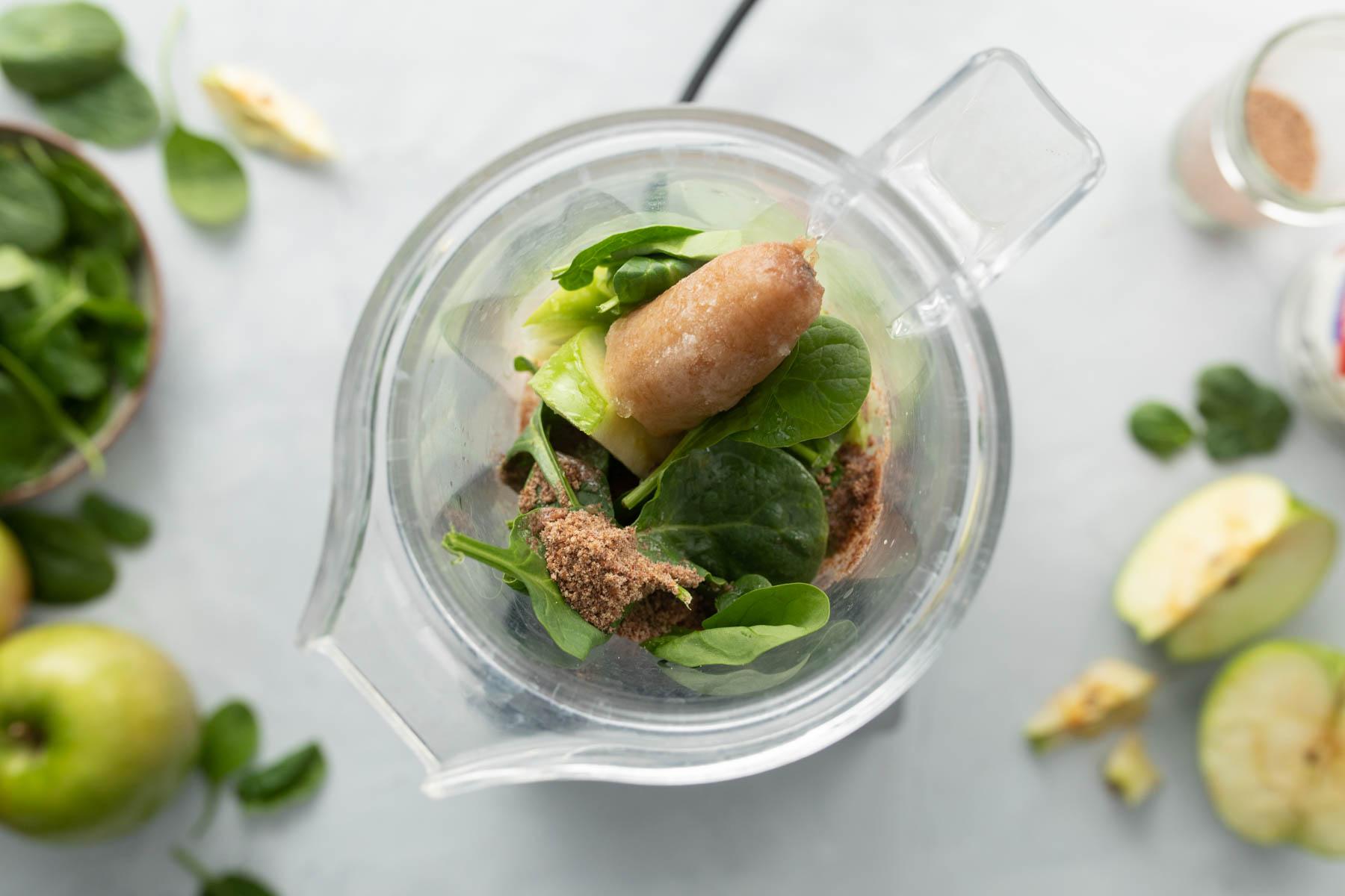 spinach, frozen banana, other ingredients in blender jar