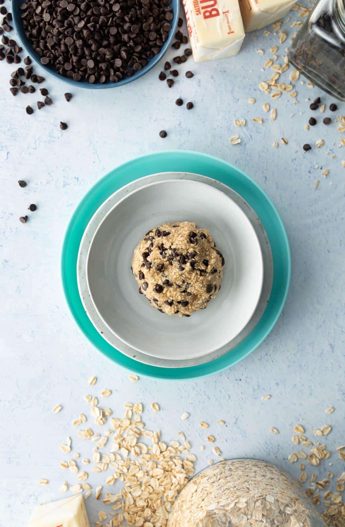 chocolate chip cookie dough on plates with ingredients around