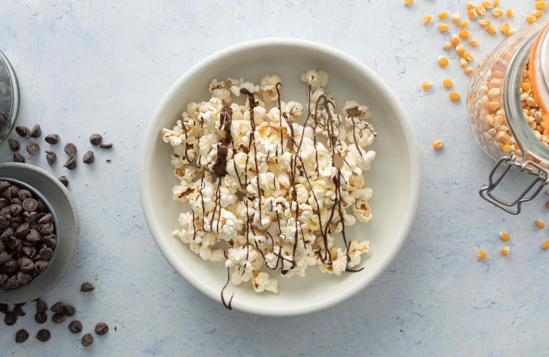 popcorn with chocolate drizzled on top in bowl