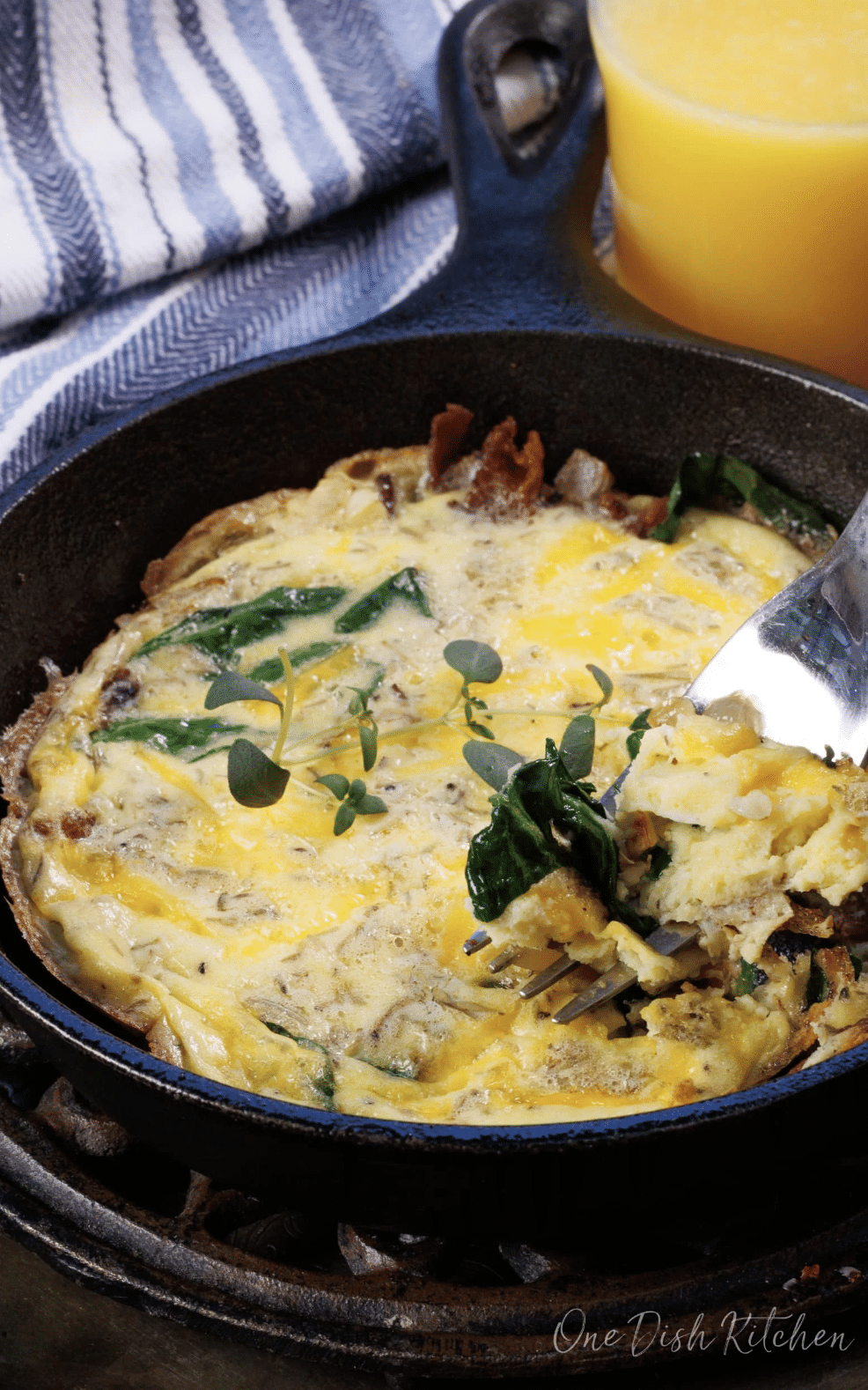 fork with frittata with frittata in small cast iron skillet