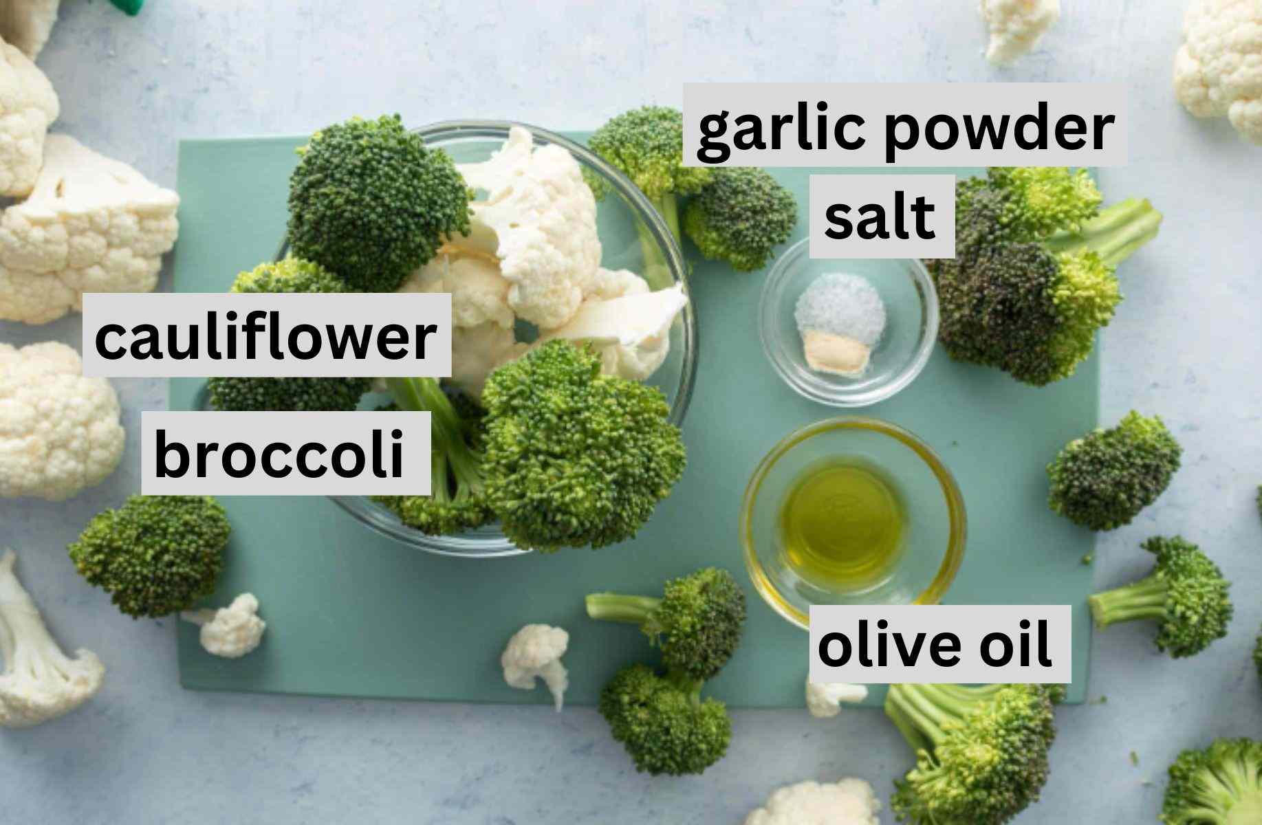 broccoli, cauliflower, seasonings on cutting board