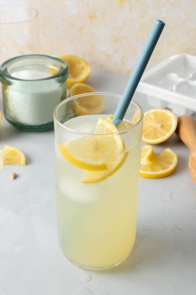 glass with blue straw, lemon slices