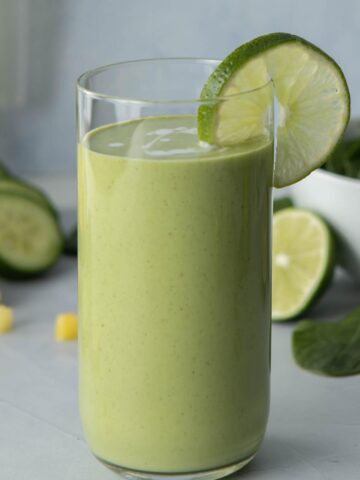 green drink in glass with lime slice