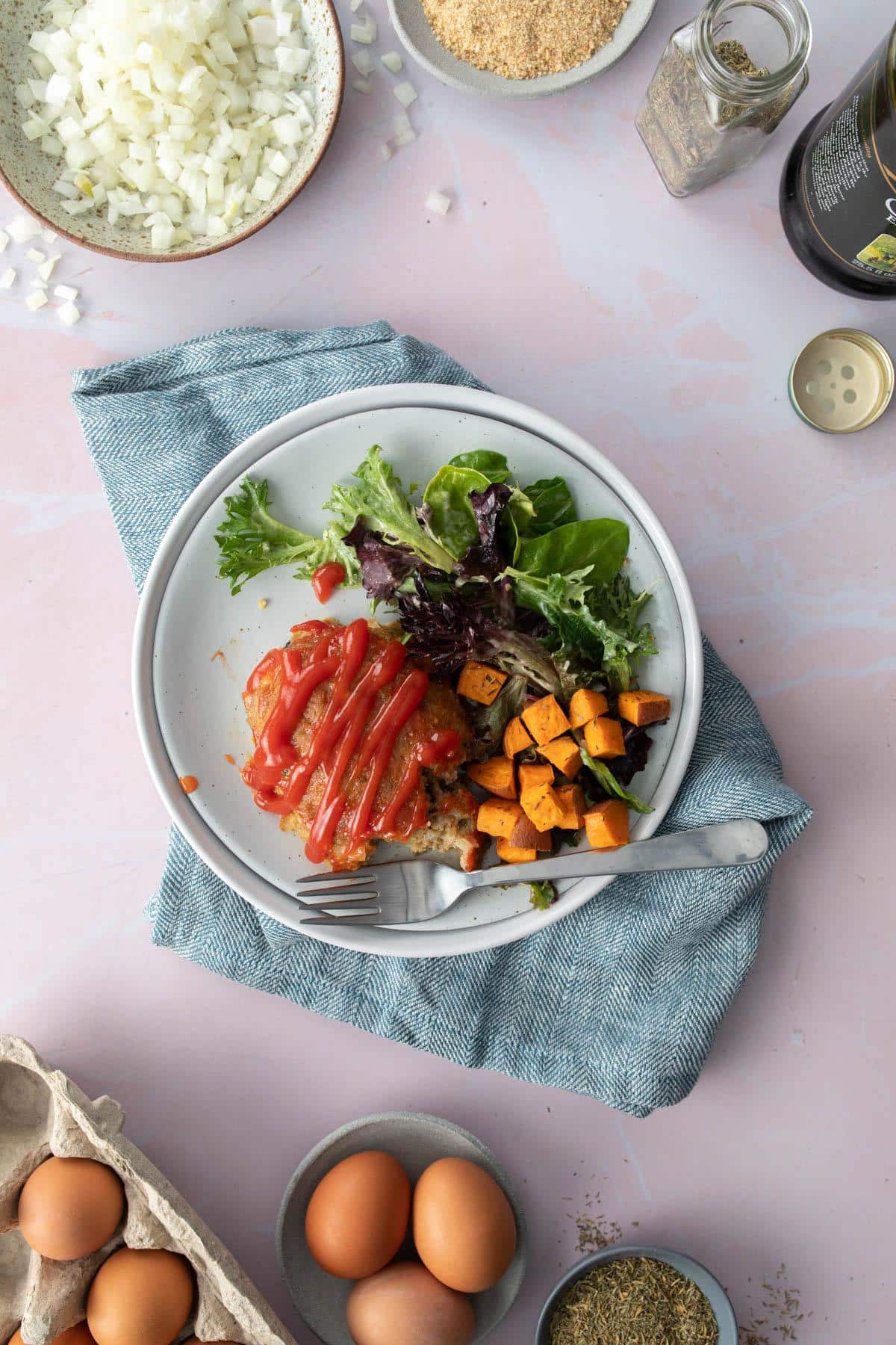 plate full of meatloaf, sweet potatoes, and salad