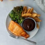 plate full of salmon, roasted broccoli, fries, bbq sauce