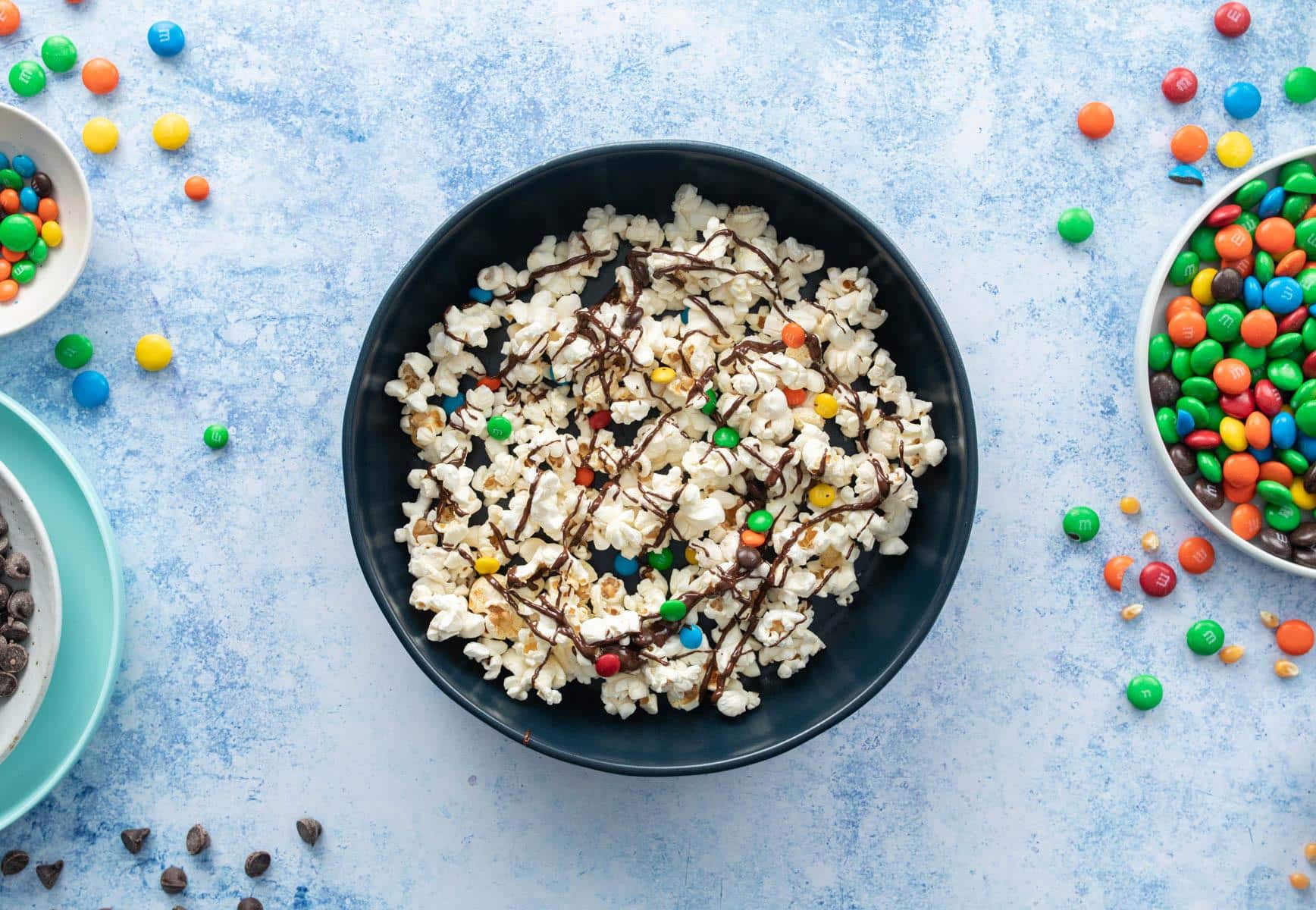 bowl with some popcorn with candy and chocolate in it