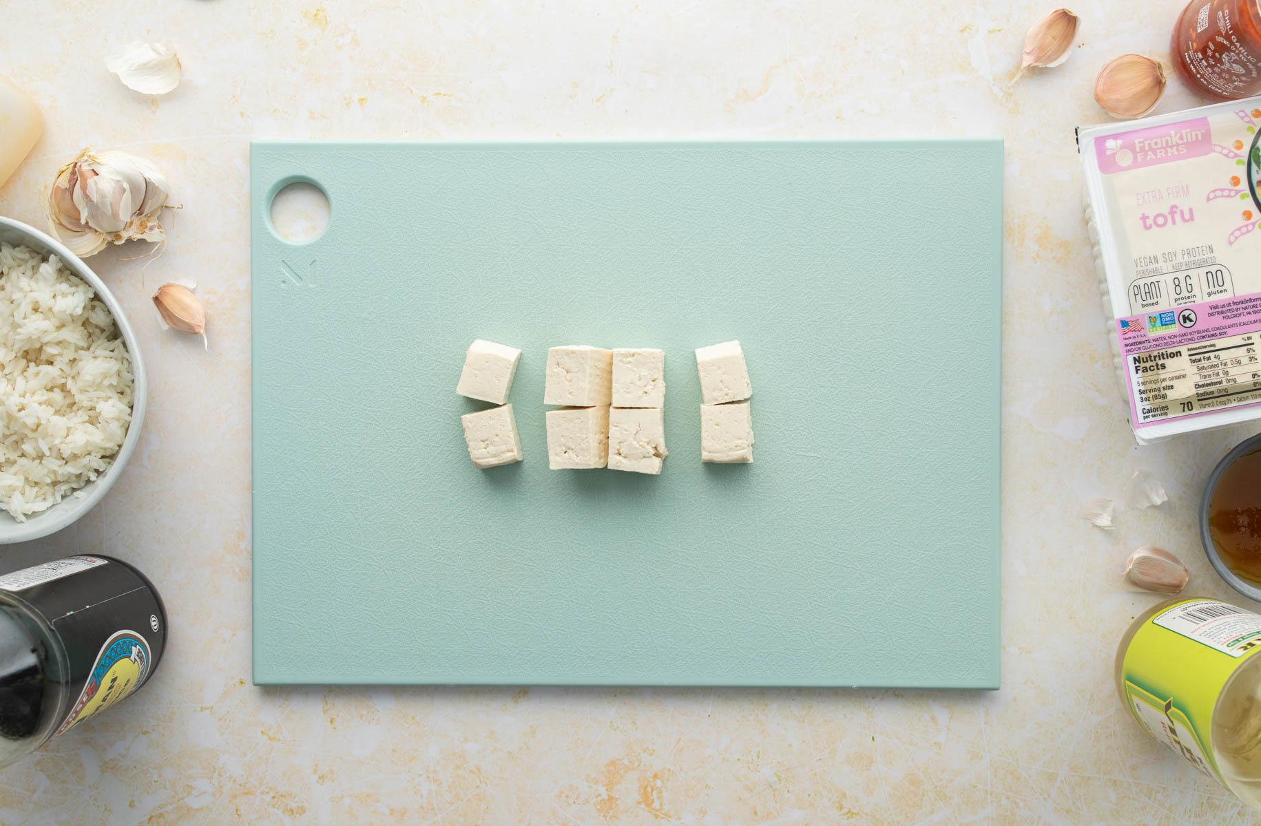 cubed tofu on blue cutting board