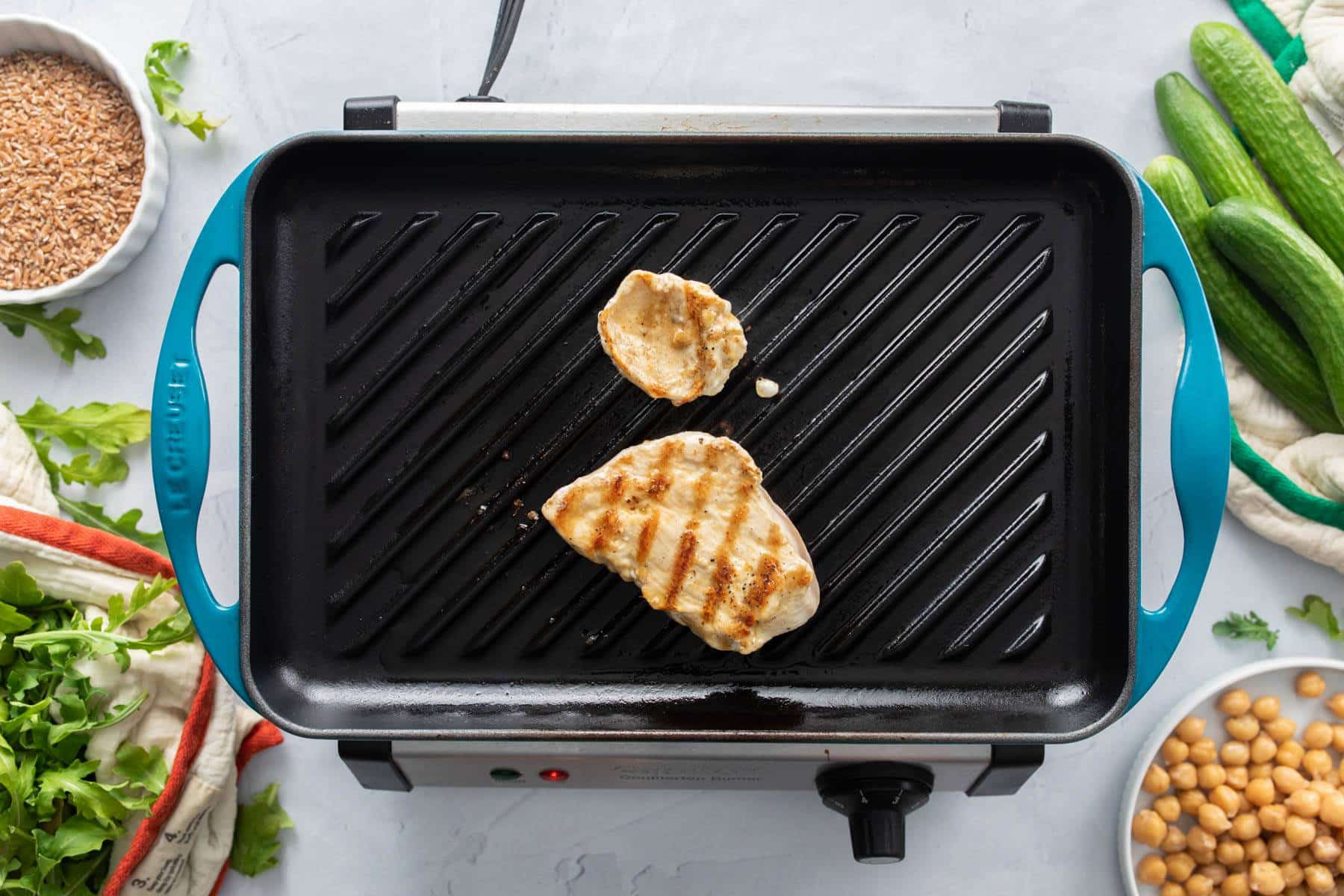 chicken breast with char marks on grill pan