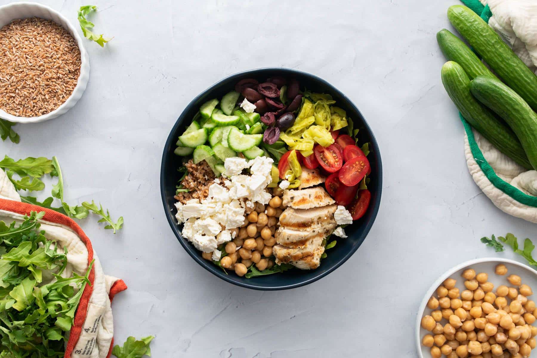 vegetables, grains, chicken, cheese in bowl