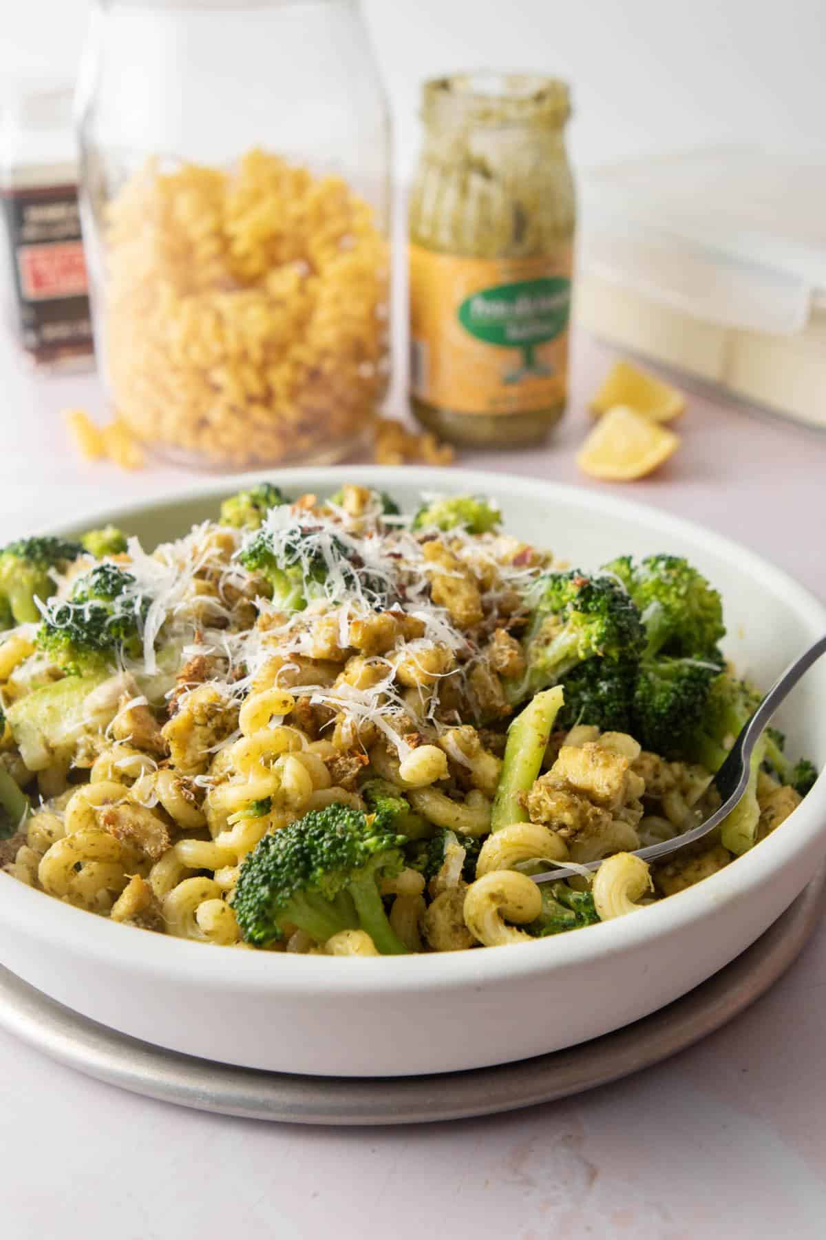 white bowl of noodles, broccoli, tofu