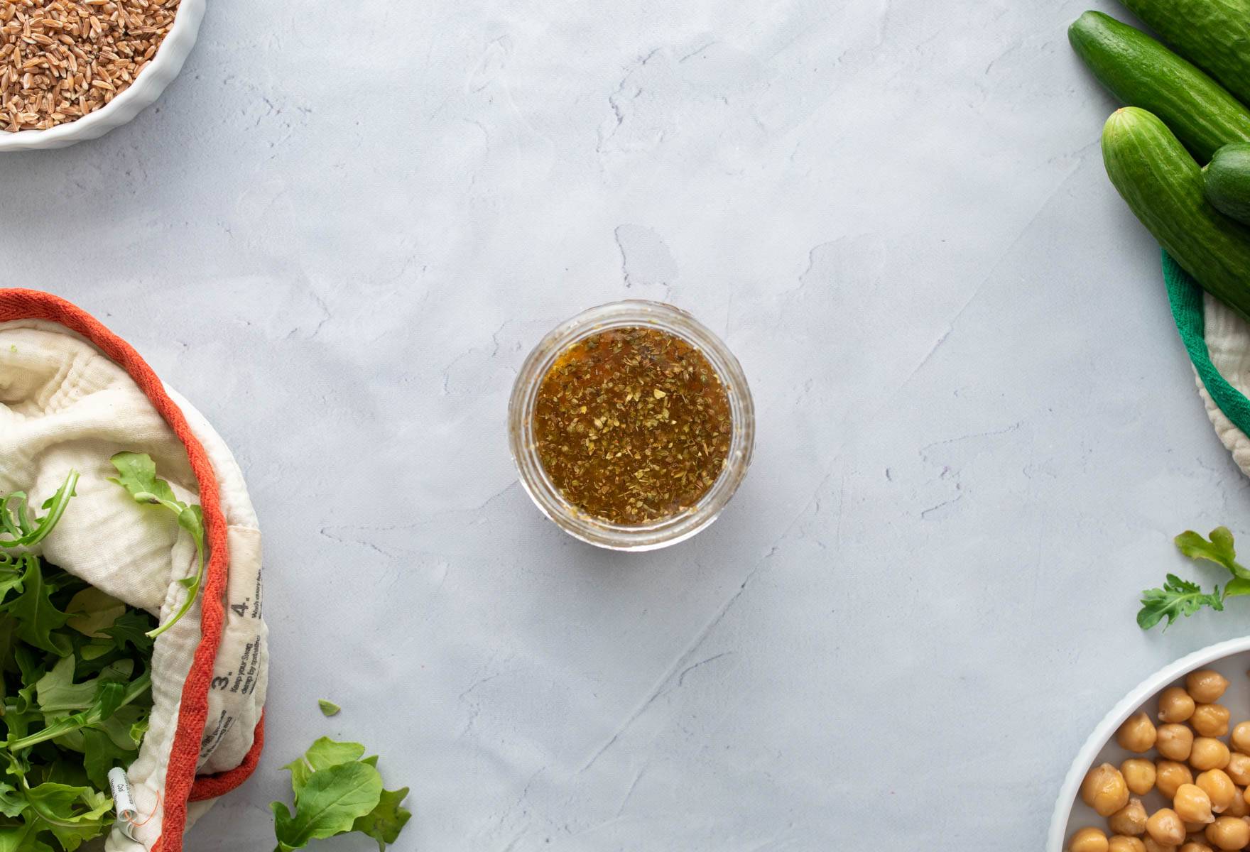 salad dressing in jar, with ingredients around