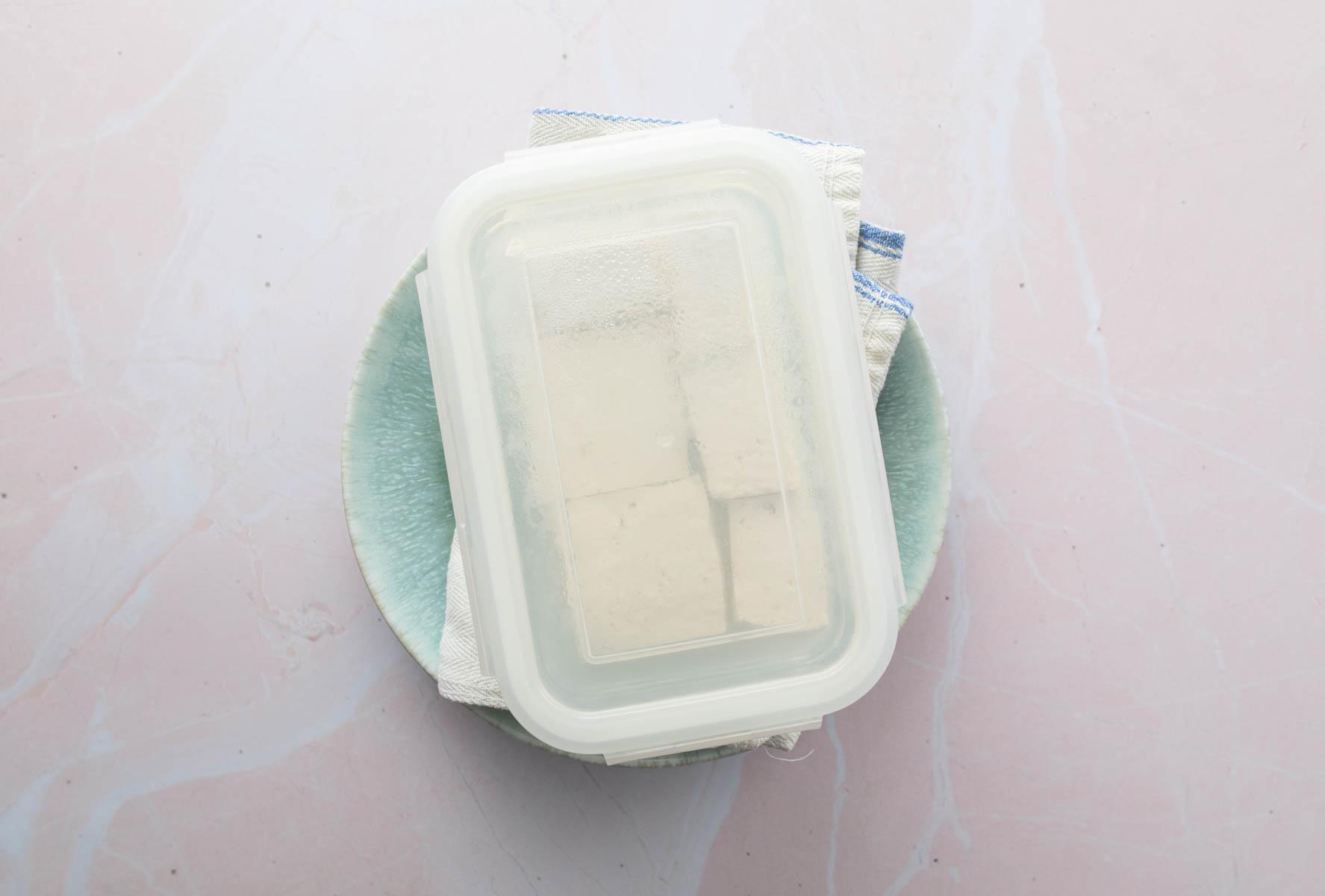 container of tofu with lid on top