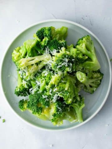plate with cooked broccoli on it