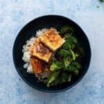 three slices of fried tofu, broccoli in bowl