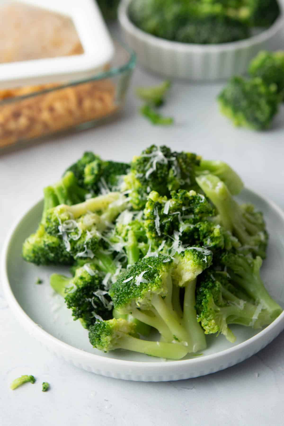 pile of broccoli with parmesan cheese on plate