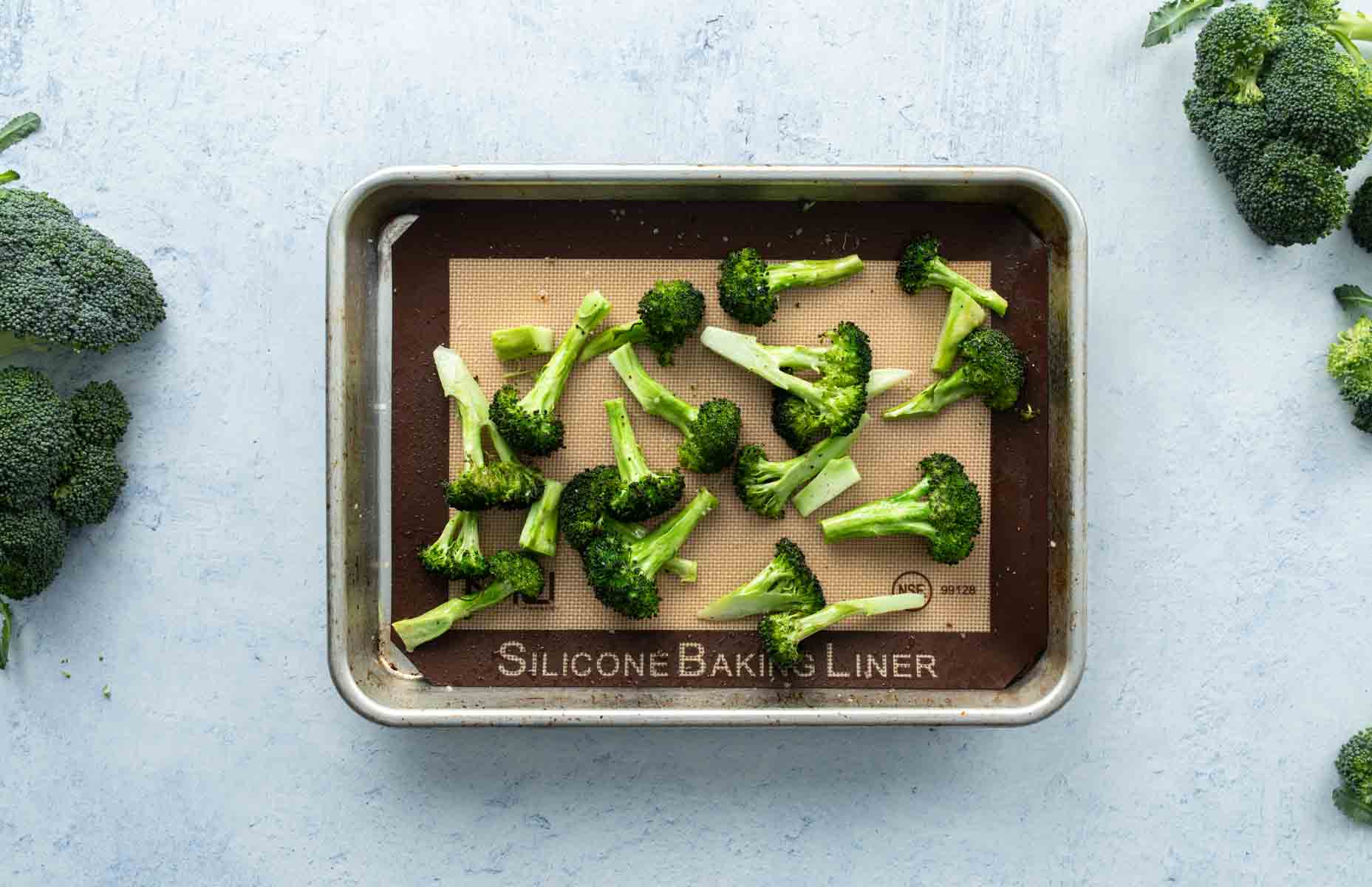 roasted broccoli florets on baking sheet