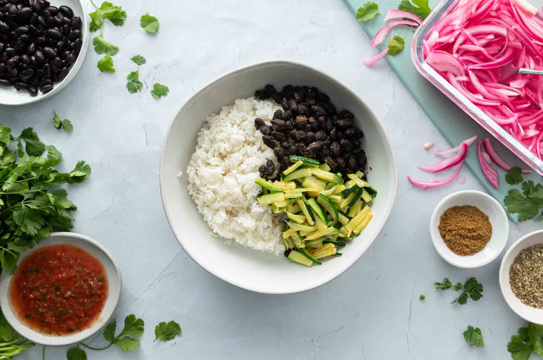 white rice, sliced zucchini, black beans in bowl
