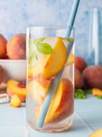 peach slices in water in glass