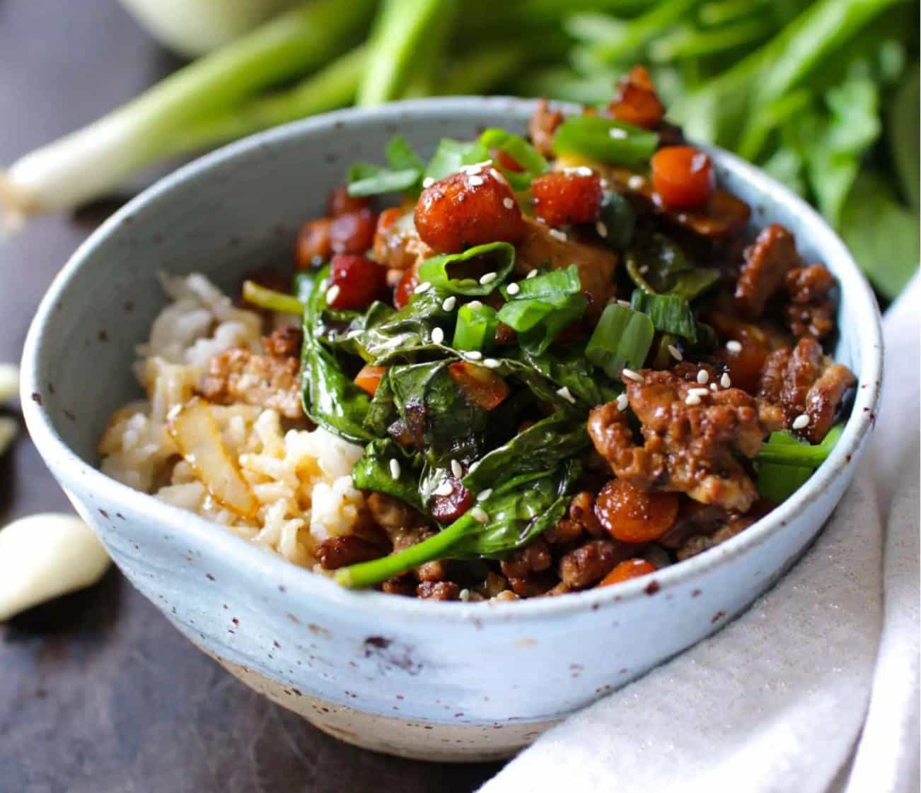 pork and vegetables with cilantro over rice in bowl