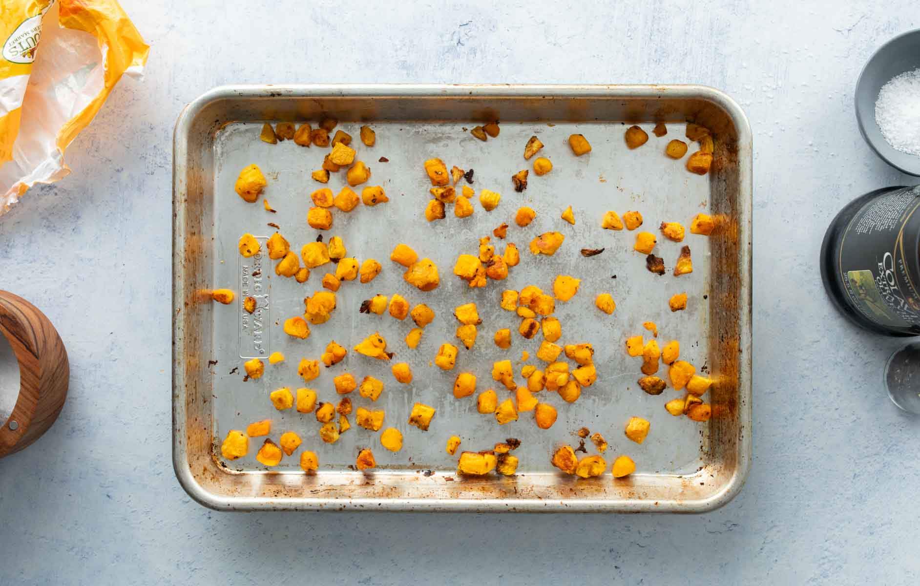 small chunks of roasted butternut squash on pan