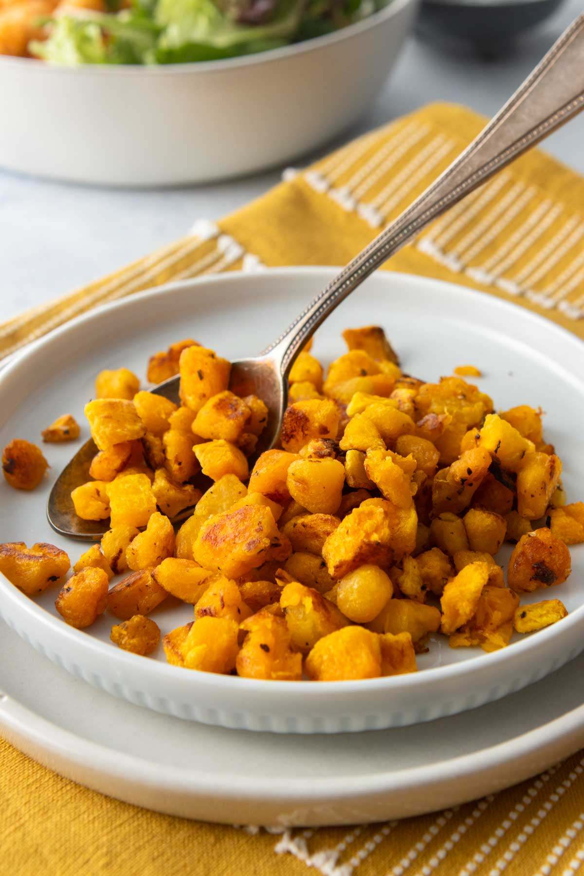 plate of roasted frozen butternut squash with spoon