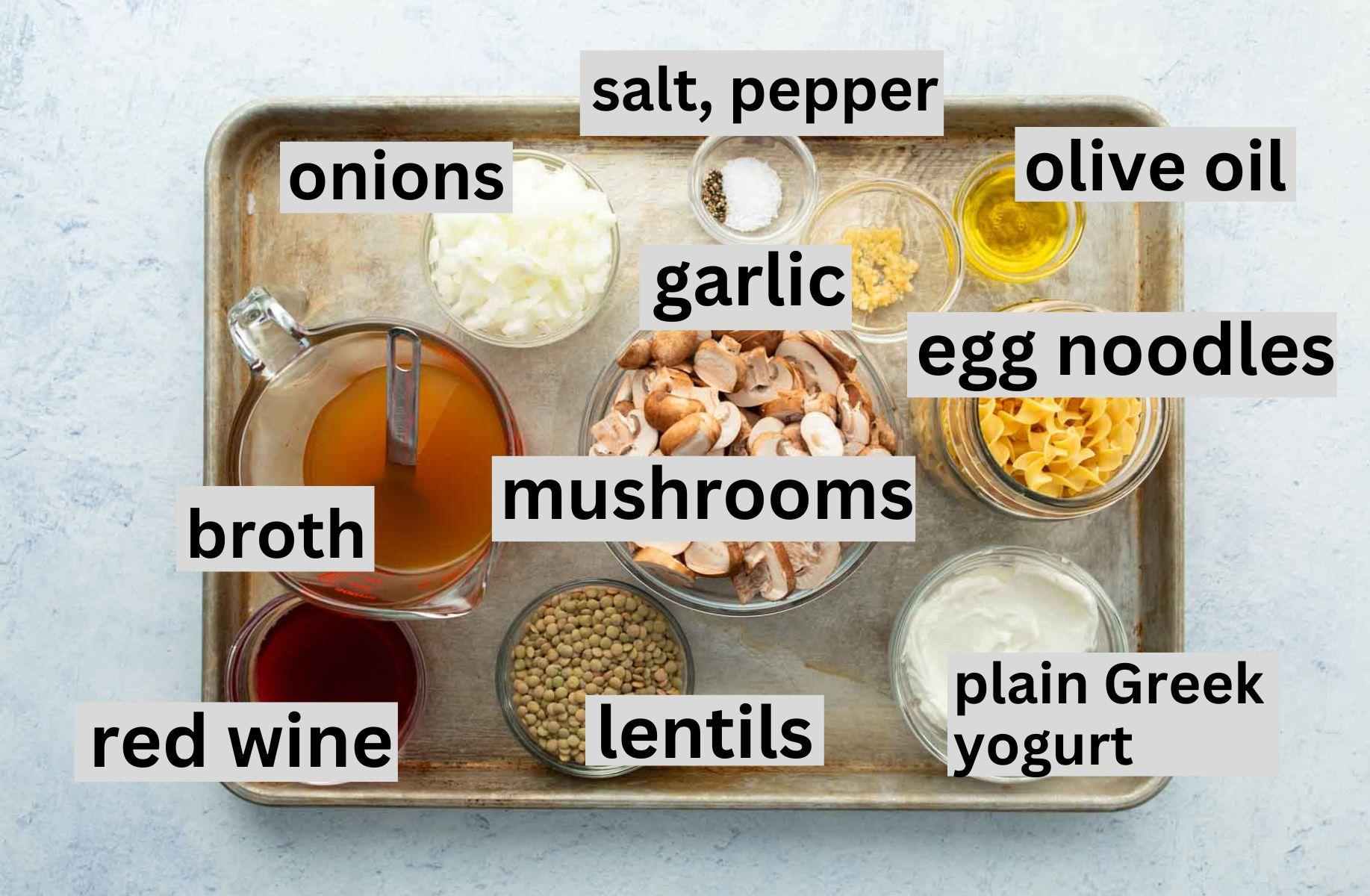 vegetarian stroganoff ingredients (with labels) on baking sheet