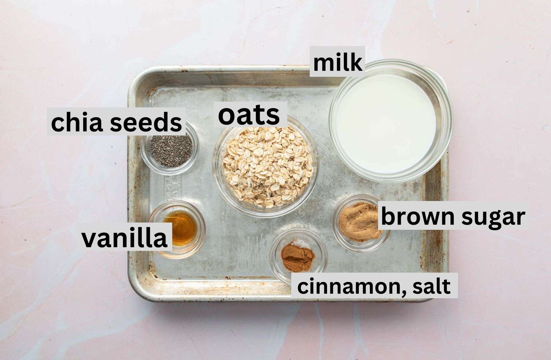 oats, milk, seasonings on baking sheet with labels
