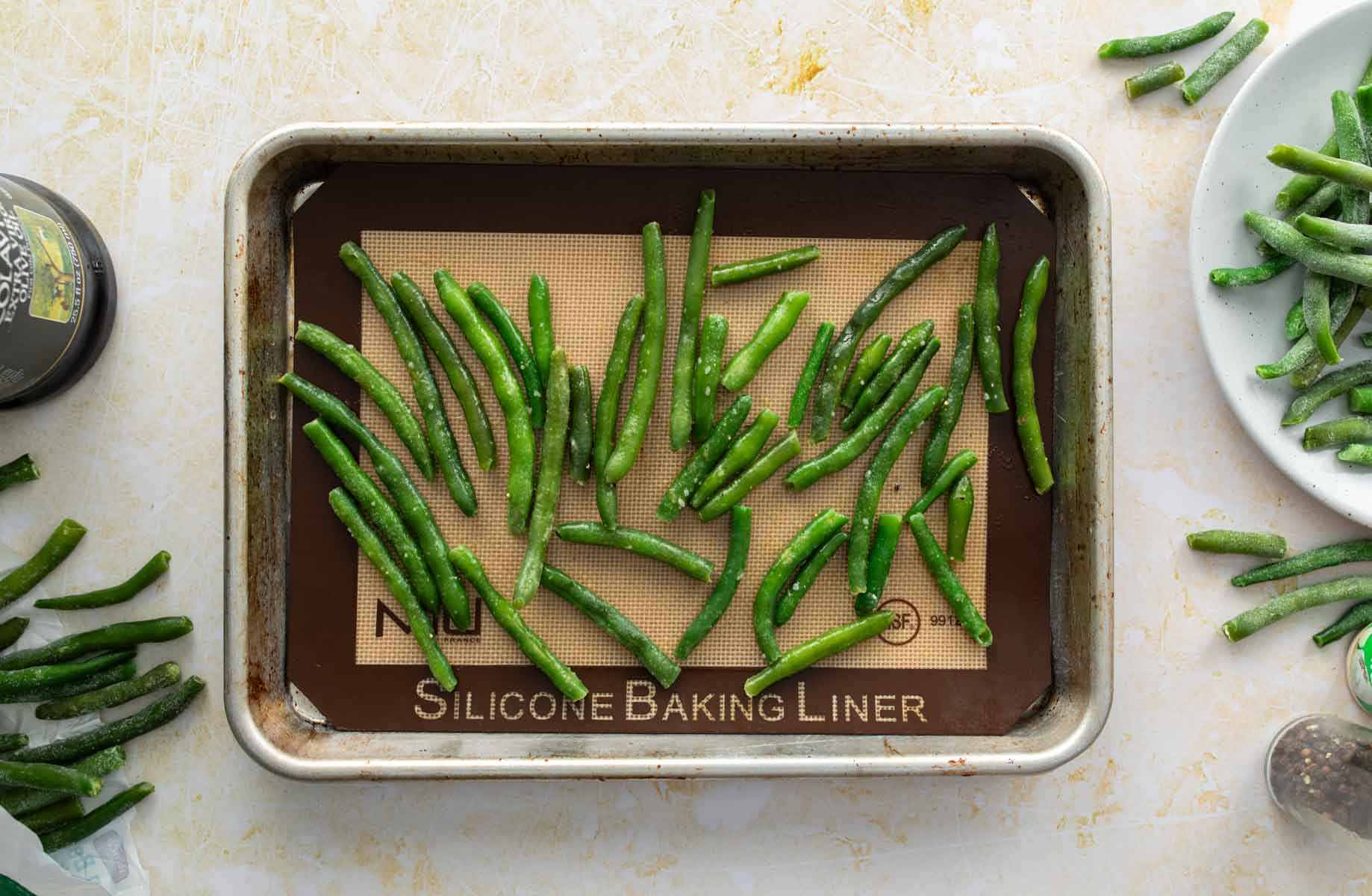 uncooked green beans on baking sheet