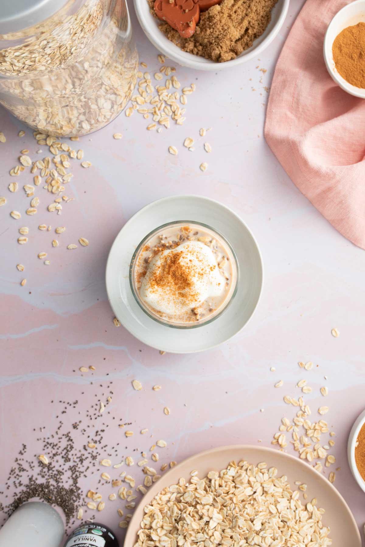 oats in glass with yogurt and cinnamon sprinkled on top